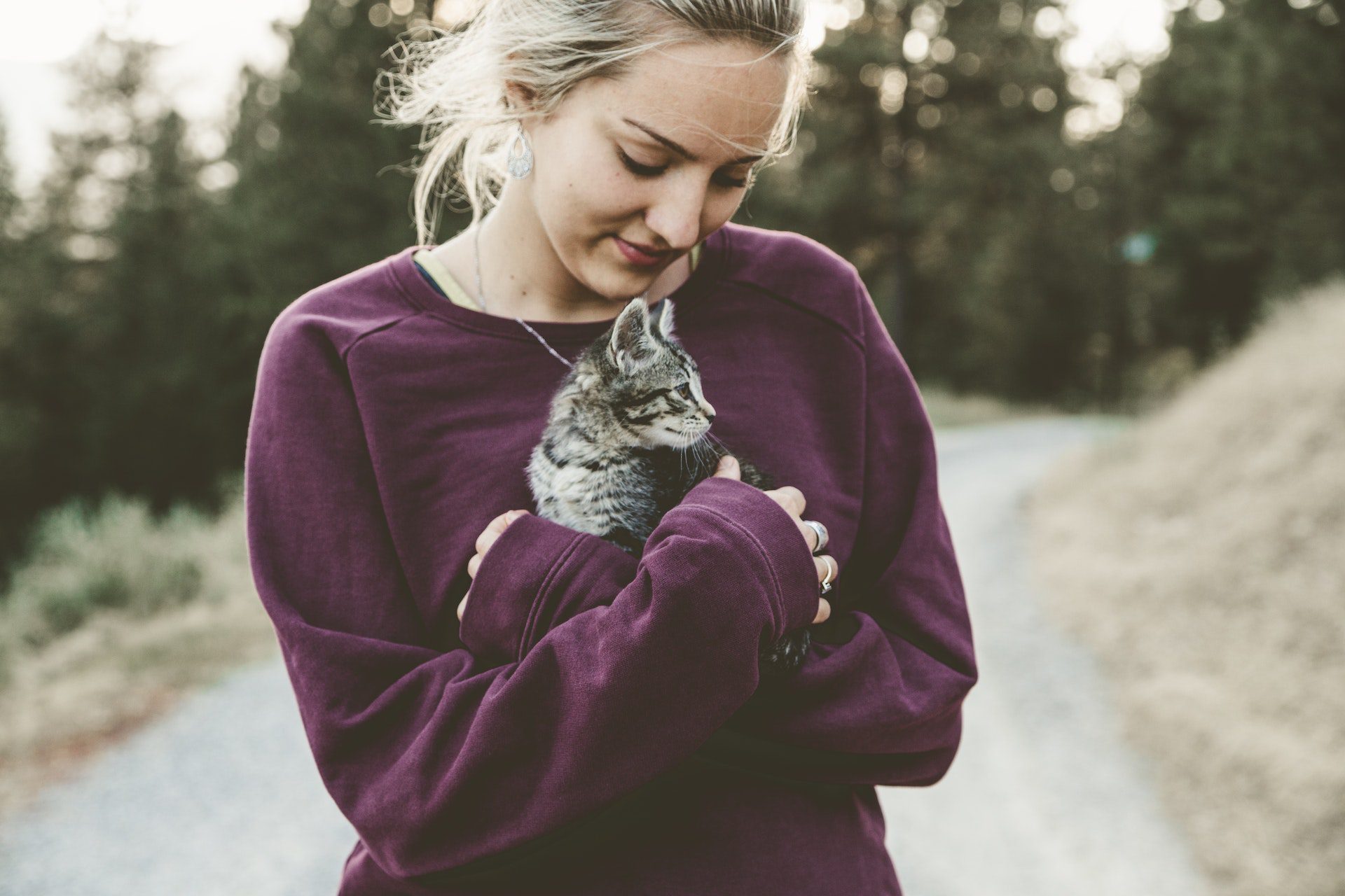 A young woman holding a cat